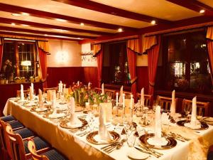 a dining room with a long table with white table cloth at Hotel Krone in Pfullendorf
