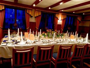 a long table with chairs and a white table cloth at Hotel Krone in Pfullendorf