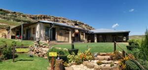 a house with a garden in front of it at Thaba Lapeng Mountain Escape in Clarens