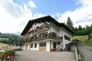a white house with a balcony on a hill at Casa Elena in Canale dʼAgordo