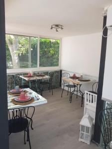 a room with tables and chairs and windows at B&B Albaluna in Valenzano