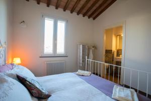 une chambre avec un grand lit et une fenêtre dans l'établissement Casa Laura Capannori, à Capannori 47 autres photos