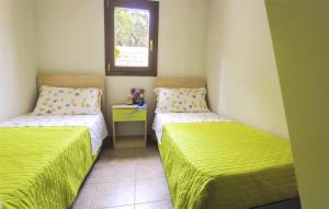 a room with two beds and a window at Agriturismo Antichi Ulivi in Mattinata