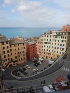a city with cars parked in a parking lot at House Camogli in Camogli