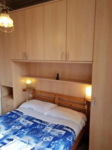 a bedroom with a bed and cabinets in a room at House Camogli in Camogli