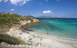 a group of people on a beach in the water at Casa Coromines in Alcudia