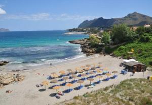 an overhead view of a beach with umbrellas and the ocean at Casa Coromines in Alcudia