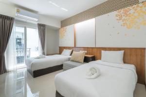 Postel nebo postele na pokoji v ubytování Cozytel Chiangmai