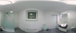 a white bathroom with a sink and a mirror at Ferienwohnung Häckel in Kurort Oberwiesenthal +12 photos