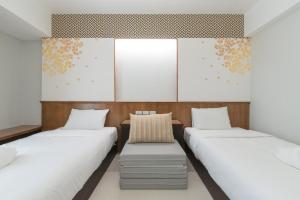 Postel nebo postele na pokoji v ubytování Cozytel Chiangmai