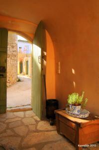 an entryway to a building with a potted plant on a table at Axion Studios in Aroniadika