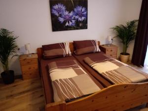2 Betten in einem Zimmer mit 2 Pflanzen in der Unterkunft Pension Chapeau-Claque in Cochem