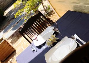 a wine glass sitting on a table with a bench at Charmant Bungalow in Saint-Pierre