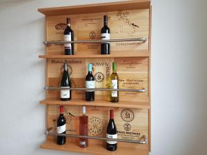 a wall mounted wine rack with bottles of wine at DOMizil Xanten in Xanten