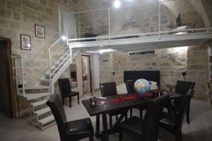 a dining room with a table and a loft bed at B&B DOMUS GAIA in Lecce