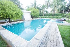 a swimming pool in the yard of a house at Jaffna Heritage Hotel in Jaffna