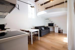 a kitchen and living room with a couch and a table at Sant'Andrea cozy apartment in Milan