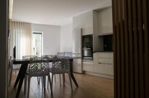 a kitchen with a dining room table and chairs at Antónia's house in Ponte de Lima