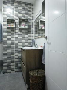 a bathroom with a sink and a counter with a stool at Sunny Beach in Málaga