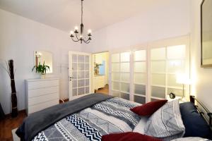a bedroom with a bed and a chandelier at M4You in Zagreb