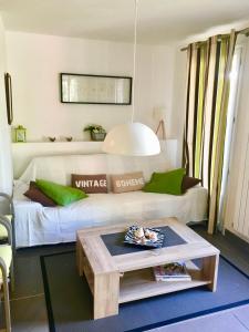a living room with a couch and a table at Les Enganes in Fréjus