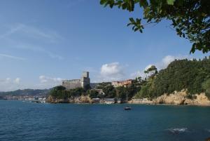 a large body of water with a castle on a hill at Casa Nene in La Spezia