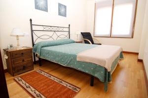A bed or beds in a room at Jardín del Sella