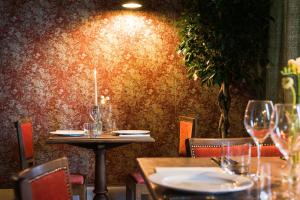 a table and chairs in a restaurant with wine glasses at The Brisley Bell in Brisley +85 photos