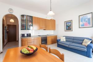 een keuken en een woonkamer met een fruitschaal op een tafel bij Petite Maison in Lido di Jesolo