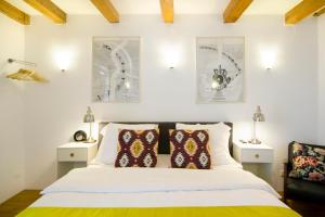a bedroom with a bed with two lamps and two pillows at Mercedes Bed&Breakfast Amsterdam in Amsterdam