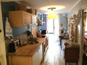 a kitchen with a sink and a counter top at La Parenthèse in Casteljaloux
