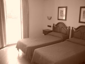 Letto o letti in una camera di Hotel Mitra Crisálida