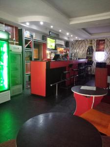 a restaurant with a bar with red and green at Pulville Boulevard in Lagos