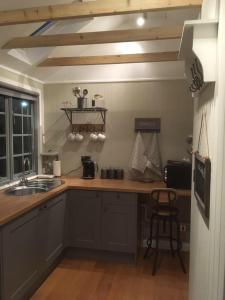 a kitchen with a sink and a counter top at Truffle Lodge in Lindfield