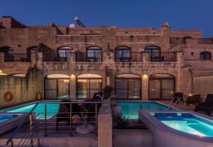 a swimming pool in front of a building at DGolden Valley Boutique in Xagħra