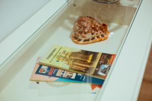 a donut and a book in a glass display case at Urban Living Apartment in Timişoara