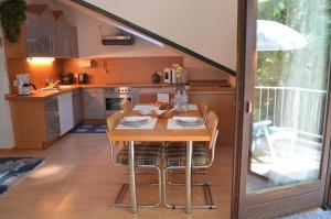 a kitchen with a table and chairs in a room at Ferienwohnung Berger in Bad Bergzabern