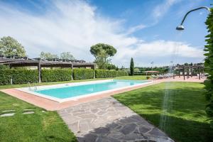 a swimming pool in the middle of a yard at Antica Pieve B&B in Tavarnelle in Val di Pesa