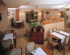 a dining room with a table and chairs and a room with tables at Hotel Hochdorfer Hirschen in Freiburg im Breisgau
