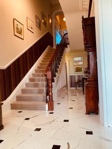 a staircase leading up to a large room with a staircase leading up to a at Aberley House in Liverpool