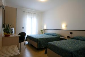 Ein Bett oder Betten in einem Zimmer der Unterkunft Hotel Al Fogo