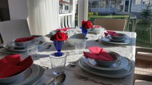 a dining table with red napkins and plates on it at PALACE KIRKPINAR in Sakarya
