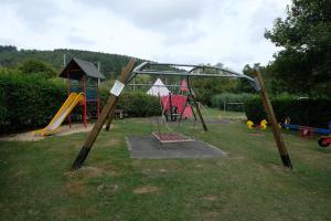 a park with a playground with a slide at Chalet Arran in Enscherange