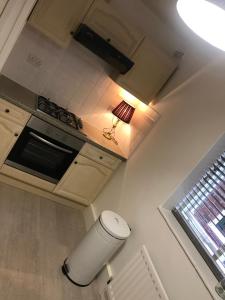 a kitchen with a trash can next to a stove at Church Lane in Newcastle upon Tyne