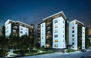 a group of tall buildings on a city street at Cosy apartment I in Târgu-Mureş