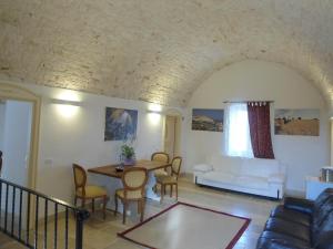 a living room with a white couch and a table at Parco dei Manieri in Conversano