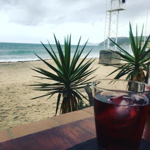 a drink sitting on a table next to the beach at Playa 2 in Níjar +4 photos