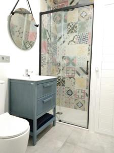 a bathroom with a blue sink and a shower at Playa 2 in Níjar