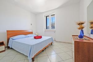 a bedroom with a bed and a window at De finibus terrae in Leuca