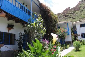 a house with a bunch of flowers in the yard at Las Portadas in Ollantaytambo